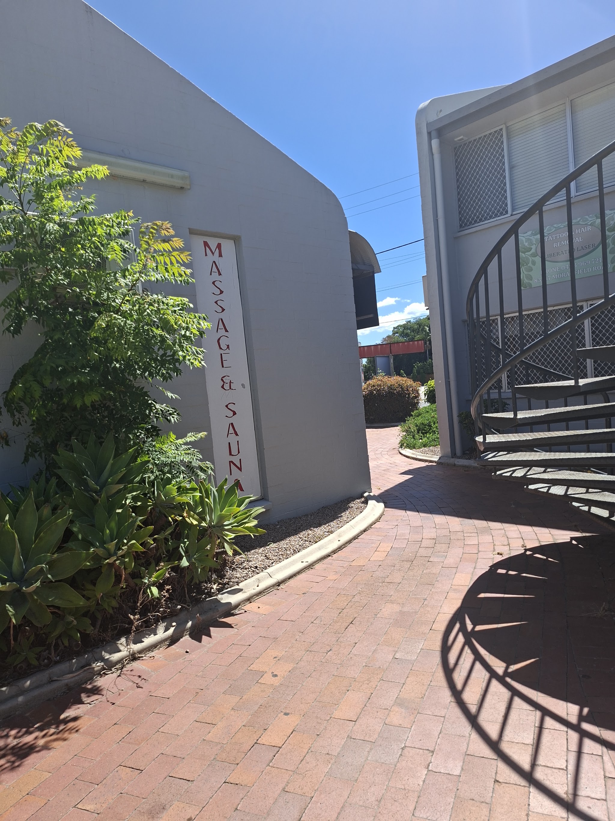 The Massage and Sauna sign on the side walkway at Silk Touch
